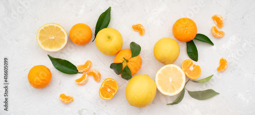 Tangerines and oranges: whole, cut and lobules with  green leaves on white background. Prepare wonderful, fresh juice every day to promote health and replenish body with vitamins. Close-up.