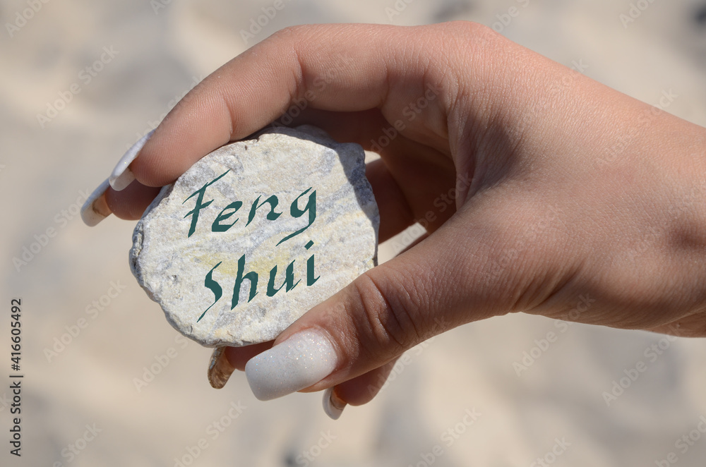 female hand helds a white stone labeled with the word female hand helds a white stone labeled with the word