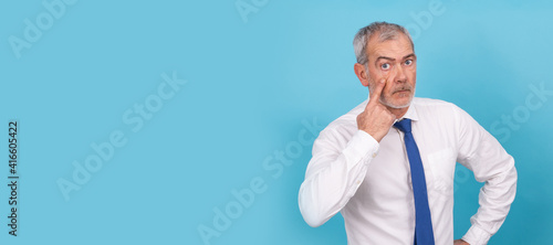 isolated businessman with distrustful expression