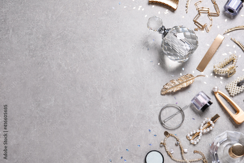 Flat lay composition with stylish hair clips and perfumes on grey background. Space for text - obrazy, fototapety, plakaty 