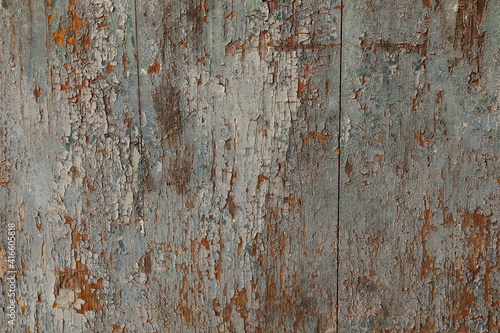 Texture of an old wooden board with scratches and peeling gray paint 