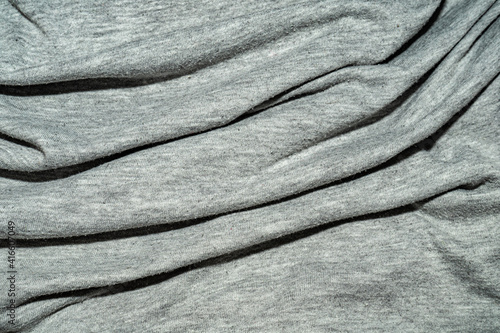 wrinkled gray cotton fabric with many folds