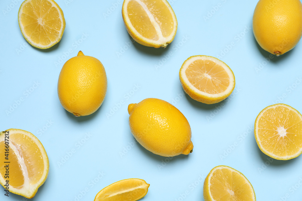 Many fresh ripe lemons on light blue background, flat lay