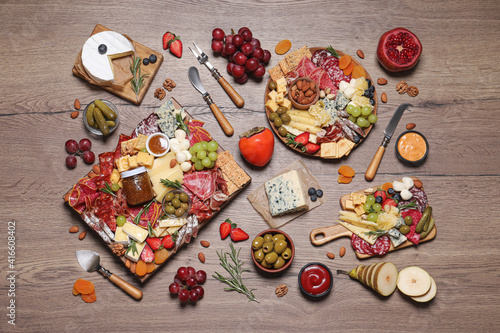Assorted appetizers served on wooden table, flat lay