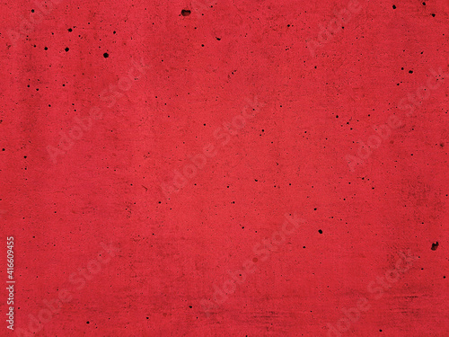 Solid red color plaster concrete wall texture background.
