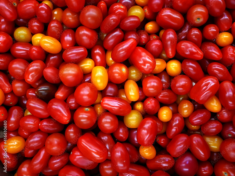 Group of fresh many small red oblong cherry tomatoes. Food background Group of fresh many small red oblong cherry tomatoes. Food background