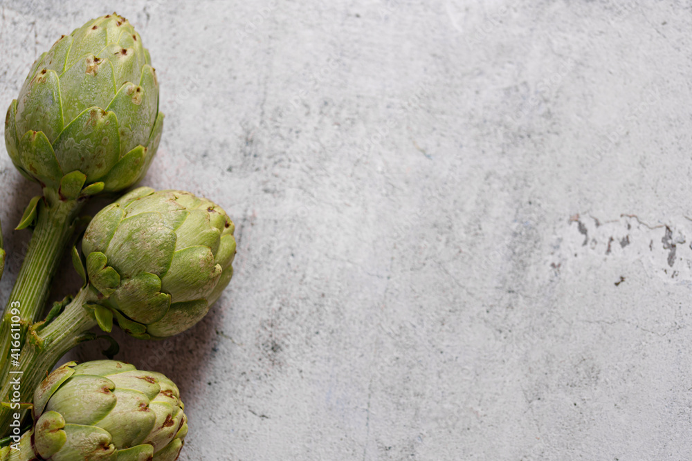 artichokes on grey background. fresh organic artichoke flower artichokes on grey background. fresh organic artichoke flower