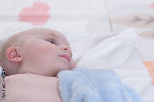 Feeling dry and happy. Happy little baby smiling while lying in bed