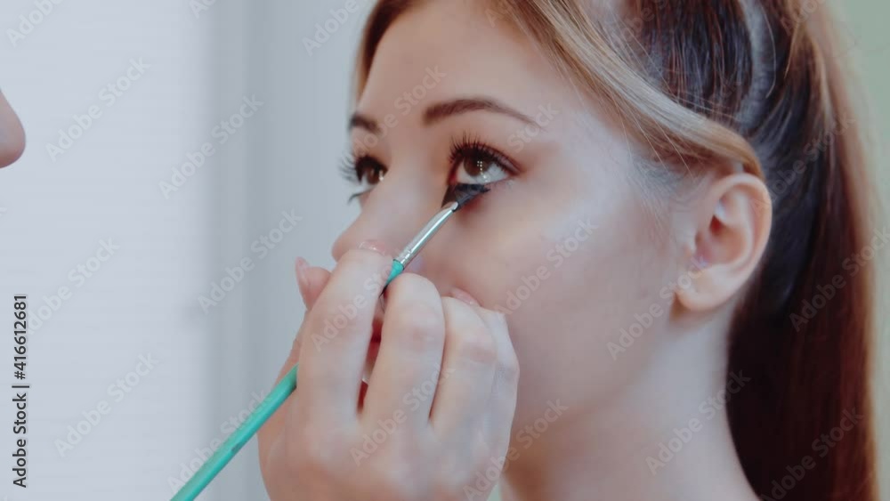 Close-up of a beautiful young woman applying mascara. Face of attractive girl applying black mascara on eyelashes, makeup, beauty, body care concept. Close-up of a beautiful young woman applying mascara. Face of attractive girl applying black mascara on eyelashes, makeup, beauty, body care concept.