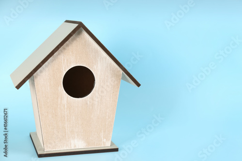 Beautiful bird house on light blue background, space for text