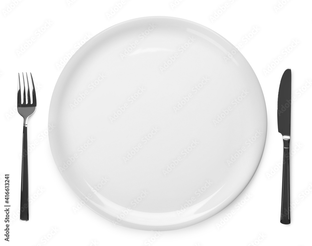 Plate and cutlery on white background, top view Plate and cutlery on white background, top view