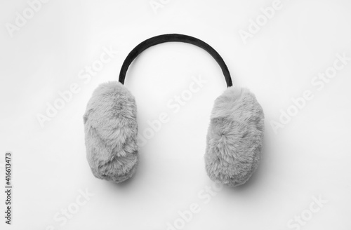 Stylish winter earmuffs on white background, top view photo