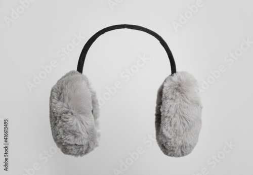 Fluffy earmuffs on white background. Stylish winter accessory photo