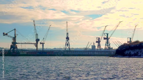 CHERNOMORSK, UKRAINE - JANUARY 29, 2021: Industrial landscape. Port cranes and ships in the seaport, Ukraine photo