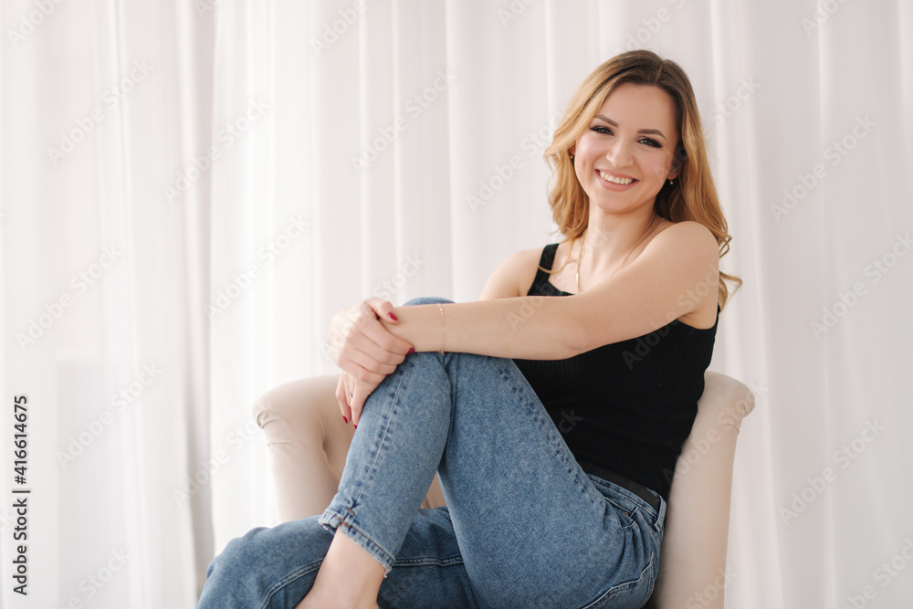 Photo of young woman in studio. Female in demin and black t-shirt Photo of young woman in studio. Female in demin and black t-shirt