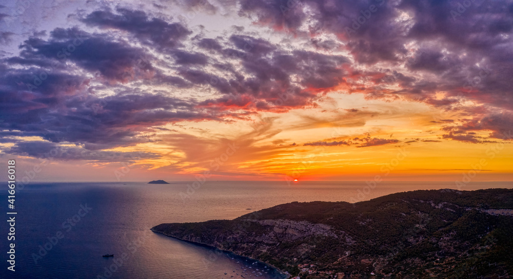 Aerial drone shot sunset over Adriatic horizon from Komiza town port on Vis Island in Croatia summer Aerial drone shot sunset over Adriatic horizon from Komiza town port on Vis Island in Croatia summer