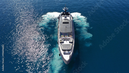 Aerial drone top view photo of latest technology modern yacht speeding in Mediterranean port with deep blue sea © aerial-drone