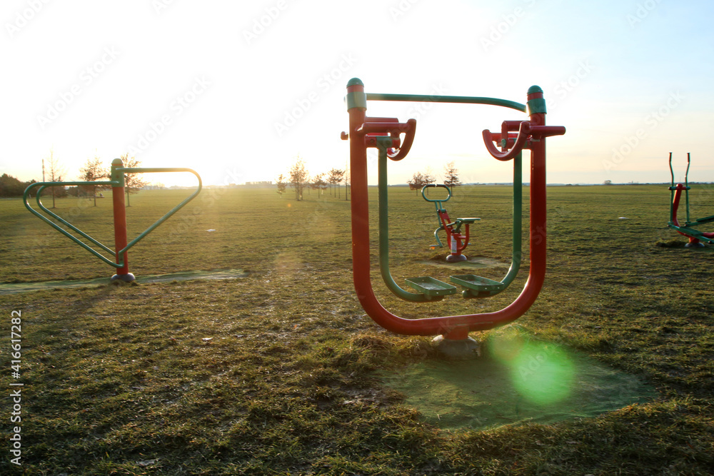 The public fitness area or playground for adults and children. They can do excersices outside on fresh air. The public fitness area or playground for adults and children. They can do excersices outside on fresh air.
