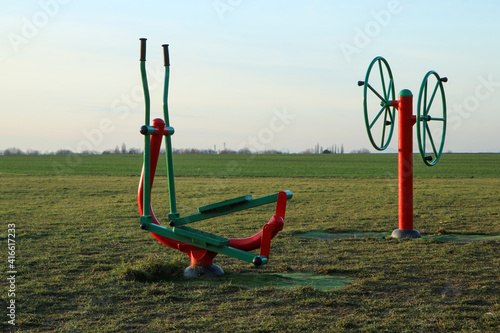 The public fitness area or playground for adults and children. They can  do excersices outside on fresh air.  photo