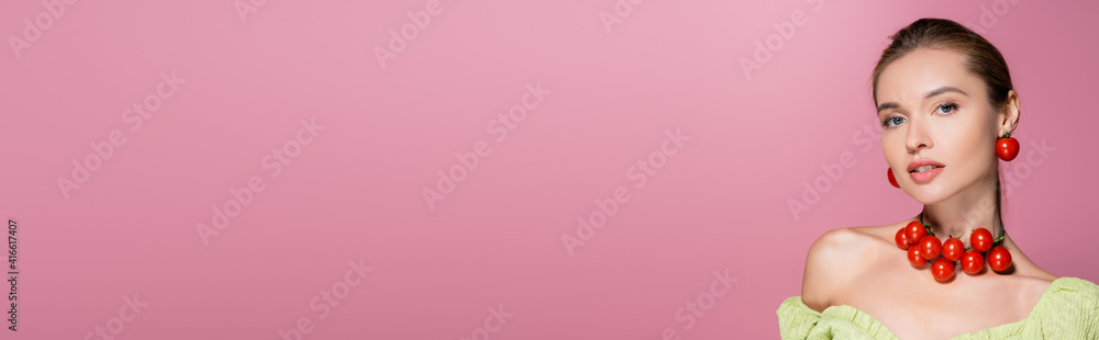 charming woman in necklace and earrings made of cherry tomatoes isolated on pink, banner charming woman in necklace and earrings made of cherry tomatoes isolated on pink, banner