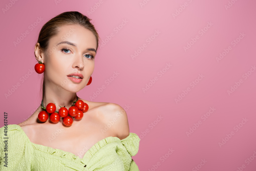 pretty woman in green blouse and necklace made of cherry tomatoes isolated on pink pretty woman in green blouse and necklace made of cherry tomatoes isolated on pink