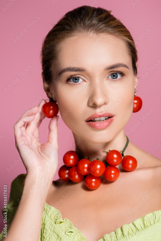 sensual woman in necklace and earrings made of red cherry tomatoes on pink sensual woman in necklace and earrings made of red cherry tomatoes on pink