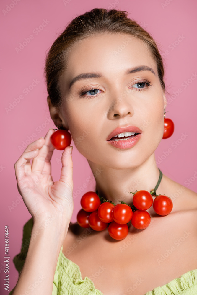sensual woman in necklace and earrings made of fresh red cherry tomatoes on pink sensual woman in necklace and earrings made of fresh red cherry tomatoes on pink