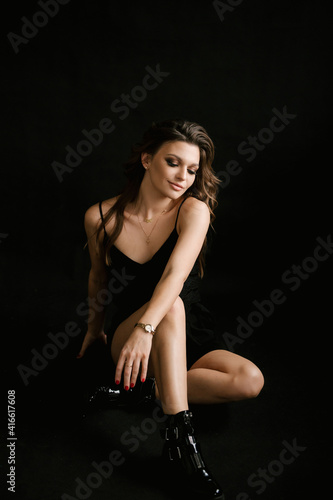 Portrait of a beautiful young sexy girl woman in a studio on a black background