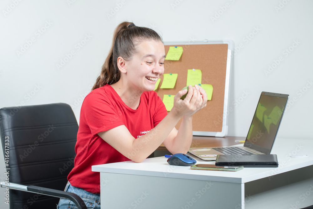 Female employee having a green apple at the office Female employee having a green apple at the office