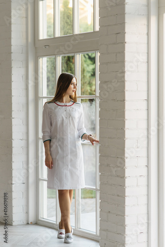 Free Download Attractive young girl in a white medical gown in a beautiful interior, VIP clinic, beauty and relaxation salon - GFXLoad