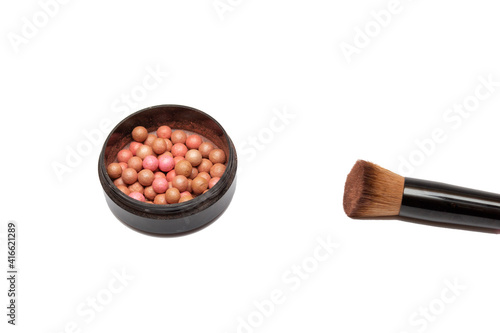 Cosmetic powder balls and makeup brush, isolated on white background.