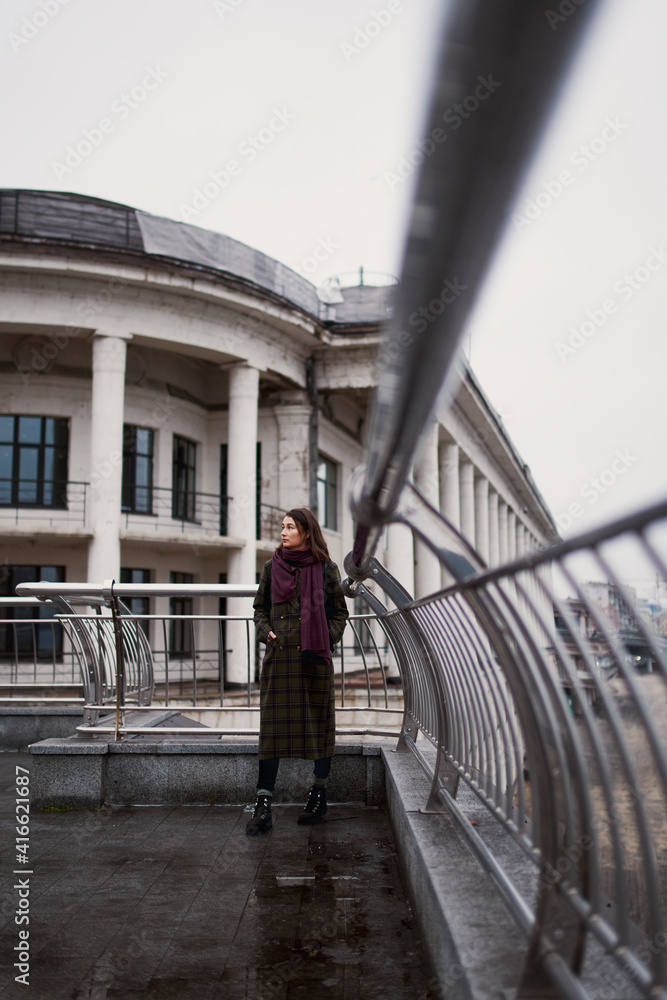 Low angle portrait of confident young woman standing in the city
