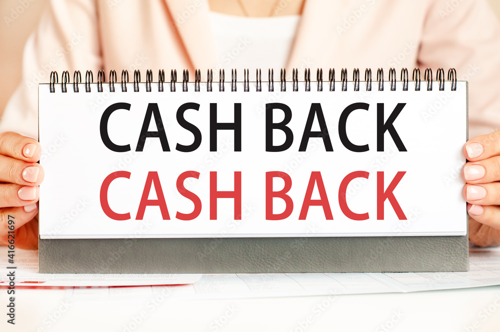 Businessman showing text CASH BACK on a cardboard Businessman showing text CASH BACK on a cardboard