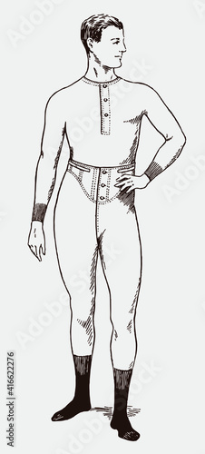 Athletic young man from the early 20th century wearing long slim fit underwear and socks