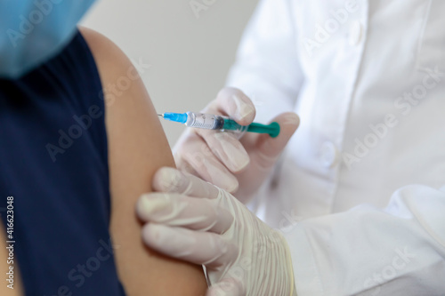 The doctor vaccinates the patient.-Influenza vaccine