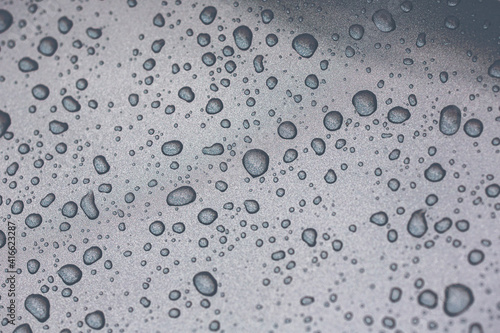 Water droplets with shallow depth of field. Macro shot of water molecule on a metal surface. Image has a vintage effect applied.