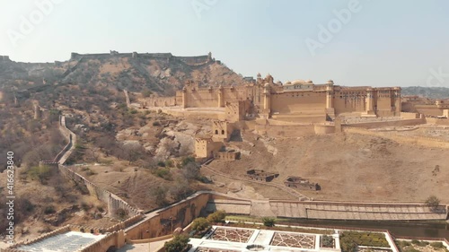 Kesar Kyari Garden in Maotha lake overlooked by Amber fort in Jaipur, Rajasthan, India - Aerial ascending fly-over shot photo