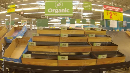 Mostly empty produce bins at the grocery store days after devastating winter storm Uri; food shortages managed thru purchase limits and reduced store hours