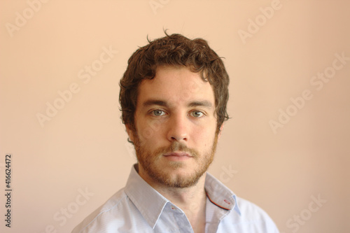 Fototapeta Naklejka Na Ścianę i Meble -  Portrait of an handsome young man with gray eyes, beard and brown hair.