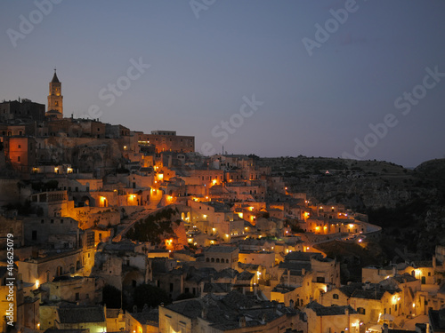 Evening view of the italian city of Matera with colorful warm lights.