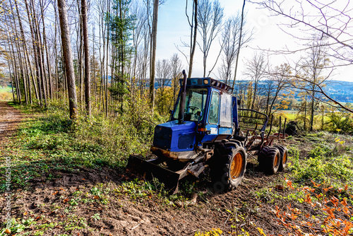 tractor stands in the woods