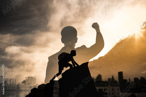 Never give up, mental strength and determination. Strong determined businessman in the city with fist in the air.  photo