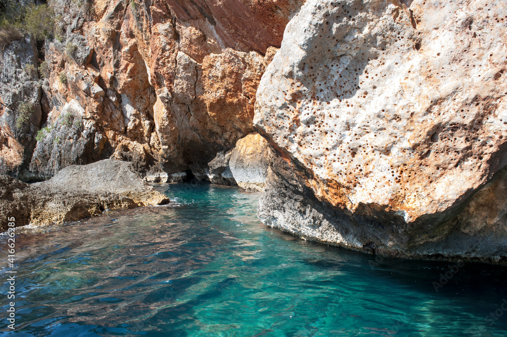 cliffside with limpid turquoise seawater, an idyllic place for scuba diving and spearfishing.
