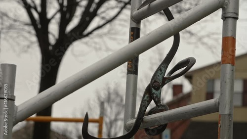 Ice tongs hanging from scaffolding, Slow Motion photo