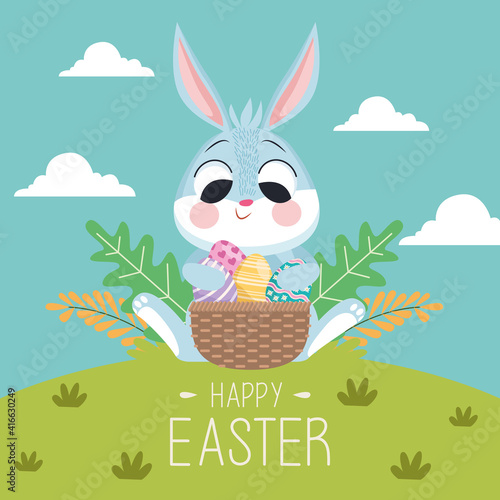 happy easter lettering card with rabbit and eggs in basket in the landscape