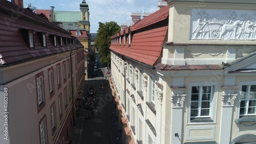 An atmospheric, historic, cobbled street leading out of the old market square in Poznań.