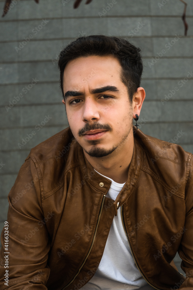 Fototapeta premium Boy in brown leather jacket posing