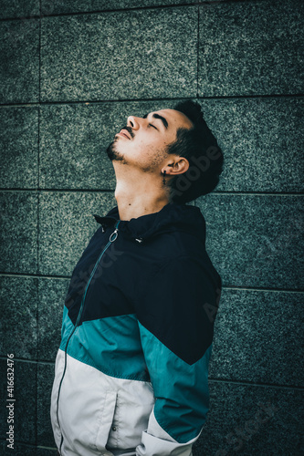 Boy with blue jacket posing