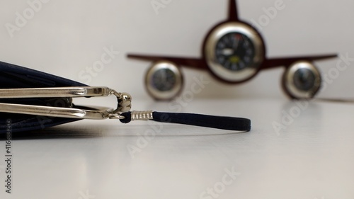 open little handbag close up on blurred background with clock like an airplane photo