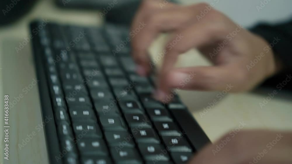Hands of worker using typing on keyboard, close up side view Hands of worker using typing on keyboard, close up side view